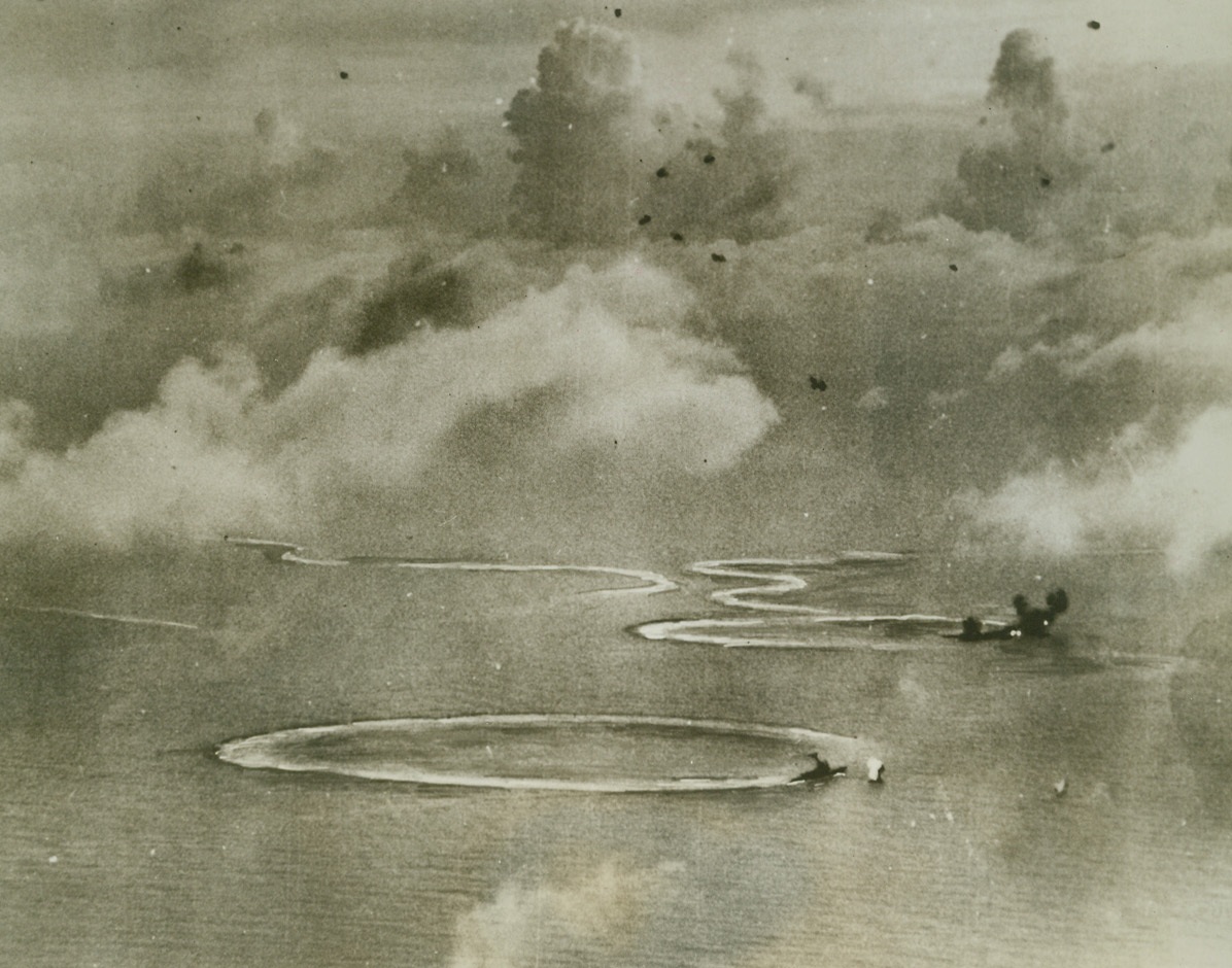 First photo – U.S. – Jap Sea Battle, 7/3/1944. Philippine, Sea – Swinging in tight circles in a desperate attempt to ward off attacks of U.S. Pacific fleet carrier-based aircraft, a Jap heavy cruiser turns counter-clockwise while throwing up a screen of flak.  Directly behind are flares of two bomb hits exploding on battleship of the Kongo class  and a carrier narrowly avoiding collision.  Action occurred between the Marianas and the Philippines on June 20.Credit (US Navy photo from ACME);