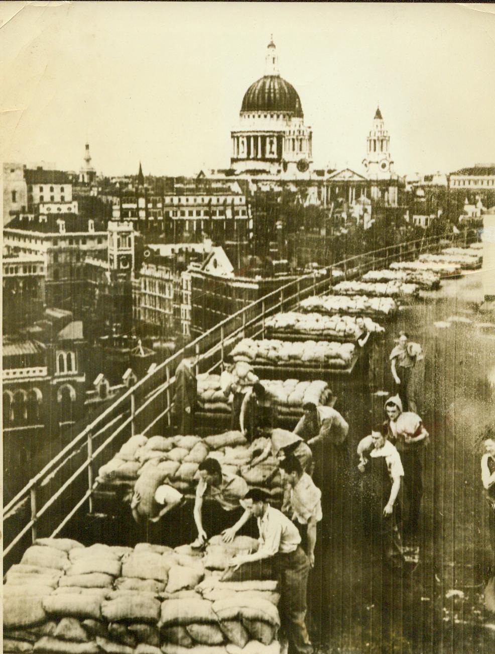 Sandbag London building as air raids precaution, 8/27/1939. LONDON – Workers sandbagging the roof on an office building in London, Aug. 27th, as the British capital continued its widespread preparations for war. The dome of St. Paul’s Cathedral may be seen in the background of this picture radioed from London. Eyes of the world were focused on London today as cabinet met in most important meeting since world war. CREDIT LINE (ACME radiophoto) 8-27-39;