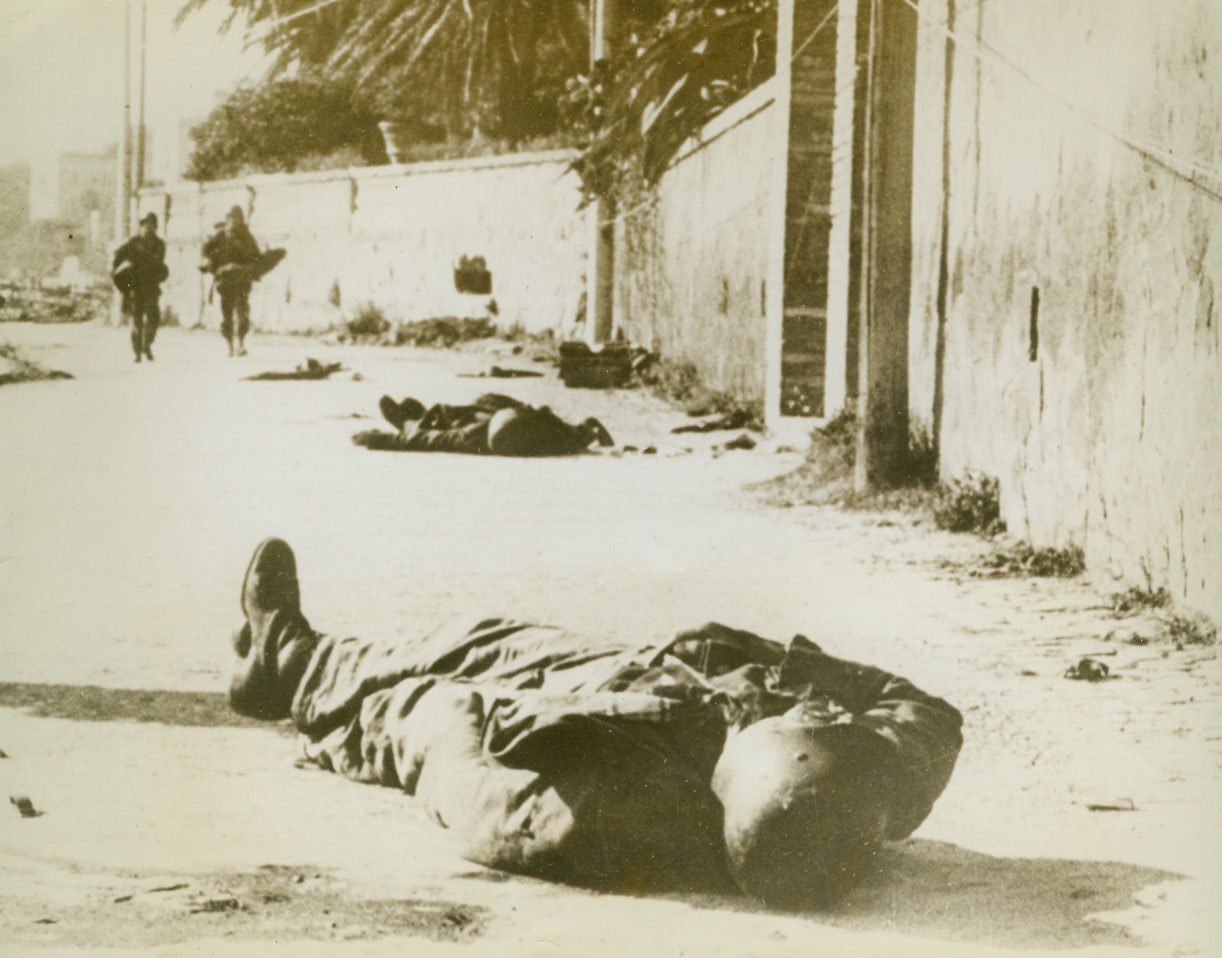 Death in the Streets, 2/9/1944. ANZIO, ITALY -- The bodies of dead German soldiers, members of the Nazi garrison at Anzio that attempted to defend the town when the Allies staged their surprise landing in January, lie in Anzio's streets. Troops of the Allied Fifth Army pass the fallen enemy warriors as they move up through the captured town. Credit Line - WP - (ACME);
