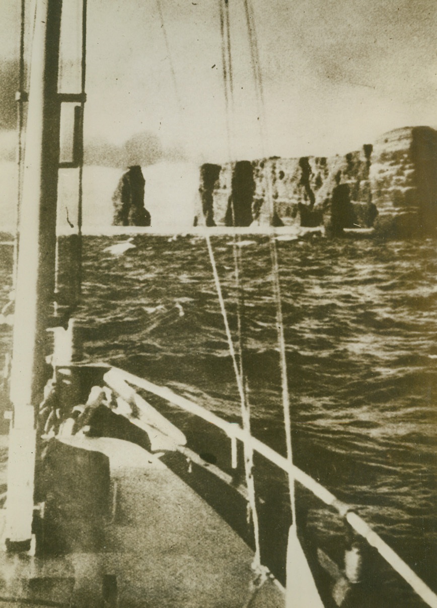 First Photos of Heligoland (#1), 2/10/1944. This photo, just received from a neutral source, is one of the first ever published  of the modern defenses of Germany’s Gobralter – the island of Heligoland, in the North Sea. Heligoland, in peacetime a tourist center, and in wartime a military and naval fortress and U-boat base, is claimed by the Germans to be “inaccessible to the enemy.” Here, is a view of the fortress from the sea. Credit Line (Acme);