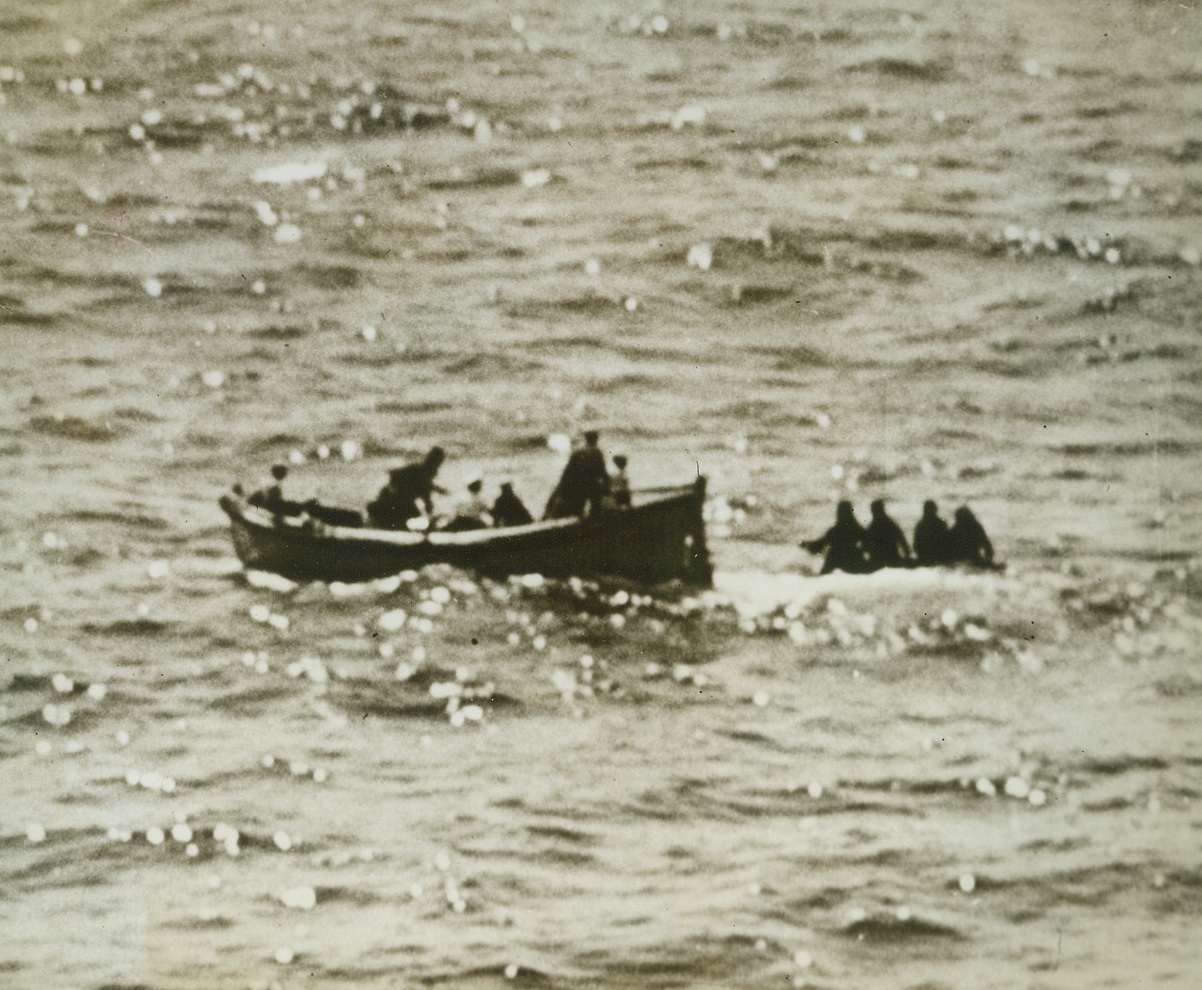 U.S.S. MARBLEHEAD RESCUES ARMY BOMBER CREW, 5/27/1943. Four members of an Army bomber crew who had been forced down at sea re picked up by a whaleboat from the U.S.S. Marblehead in a recent rescue by the famous Navy cruiser. The men spent five days on a rubber life raft in perilous seas without food and only eleven ounces of water.Credit: Off. U.S. Navy photo from Acme;