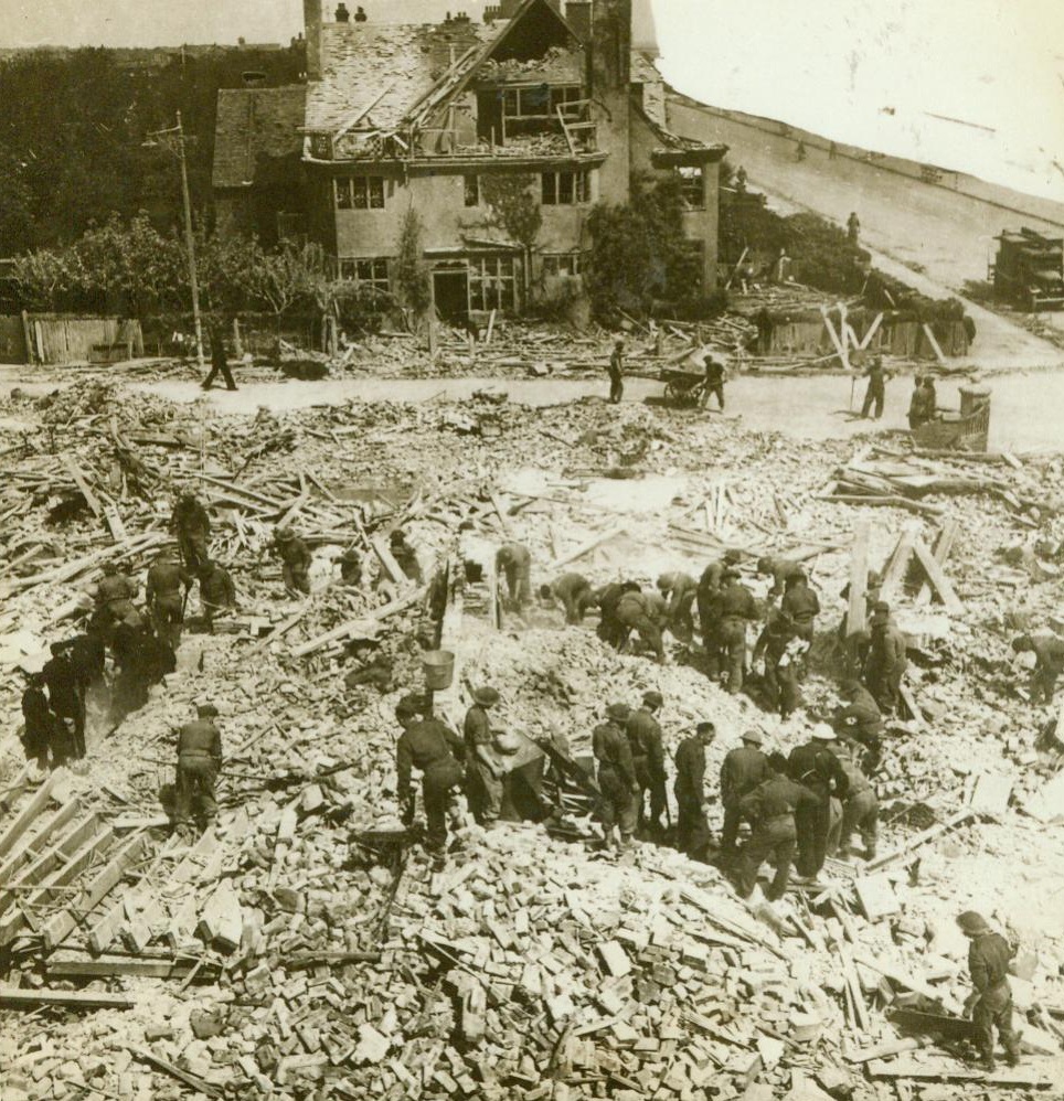 Another Nazi “Military” Target, 5/21/1943. England -- British soldiers dig in the wreckage of the Auxiliary Territorial Service Building where at least twelve girls of the organization met death when a Focke-Wulf Fighter-Bomber scored a direct hit on the hostel. Fifteen enemy planes took part in the raid on the East England coast town, bombing and machine-gunning the streets from rooftop level. There was also extensive damage done to houses. Credit: ACME;