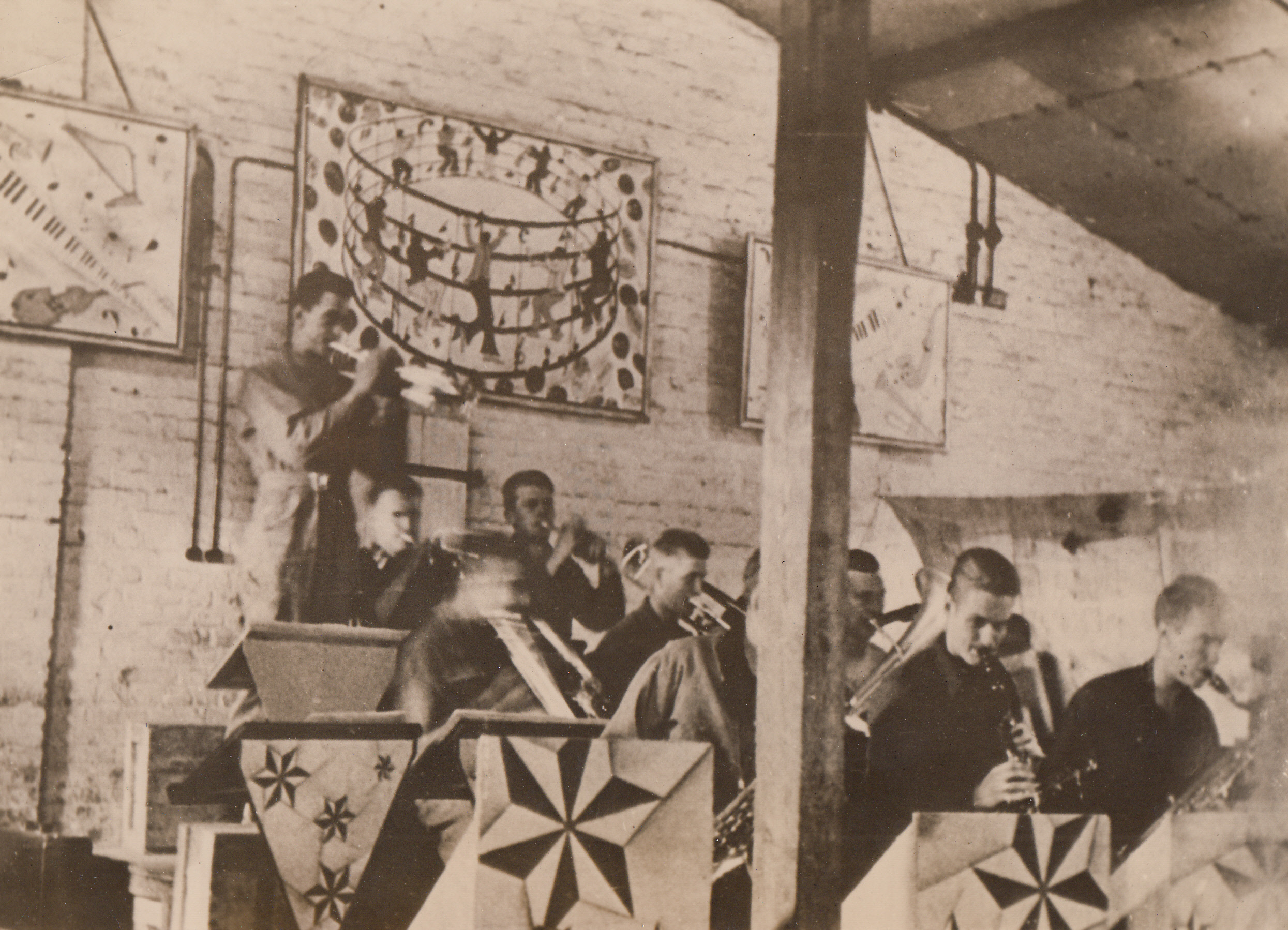 Captured Yanks Have Own Band, 10/7/1943. This photo, taken and sent to the U.S. by a Y.M.C.A. war prisoners aid delegate who visited the prison camp, shows American soldiers, captured in the North African fighting, as they gave a concert to entertain their comrades at Stalag 111B, a German prison camp Southeast of Berlin.  M/Sgt. Clyde M. Bennett, leader of the Americans in the camp, says: “we’ll soon have the best band in Germany.”;