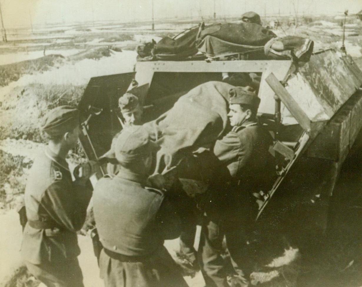 PLENTY OF BUSINESS FOR NAZI AMBULANCES, 5/21/1943. A wounded Nazi soldier is removed from an ambulance just back from a battlefield. Although the original German caption gave no location for this war scene, the snowy terrain indicates that it is somewhere on the Russian front. Photo arrived by clipper from London Credit Line (ACME);