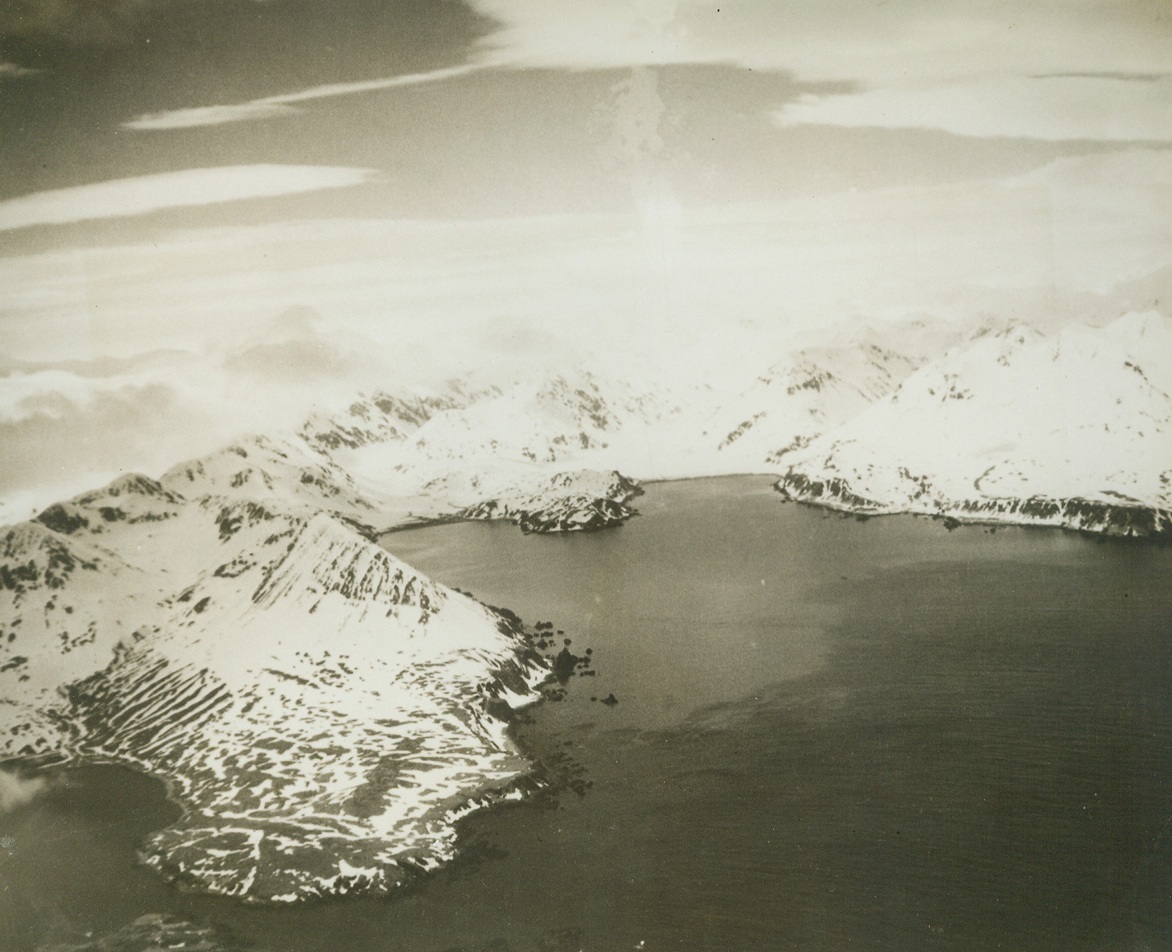 WHERE AMERICANS ADVANCED ON ATTU, 5/19/1943. Advance patrols of American forces which landed in the Holtz Bay and Massacre Bay area have joined. The tow arms of Holtz Bay are shown in the center of the photo, American forces attacked Jap positions on the high ground between the arms and took possession of the area. As the forces from Massacre Bay (not shown) advanced northward, the Holtz Bay units took possession of the high ridge to the southeast (from center of the picture to the left). The advance units from Massacre Bay and Holtz Bay met in a pass, which has been cleared of enemy troops. The troops withdrew toward Chichagof Harbor (extreme lower left). The village of Attu, only settlement on the island, faces Chichagof Harbor. Credit: U.S. NAVY PHOTO FROM ACME.;
