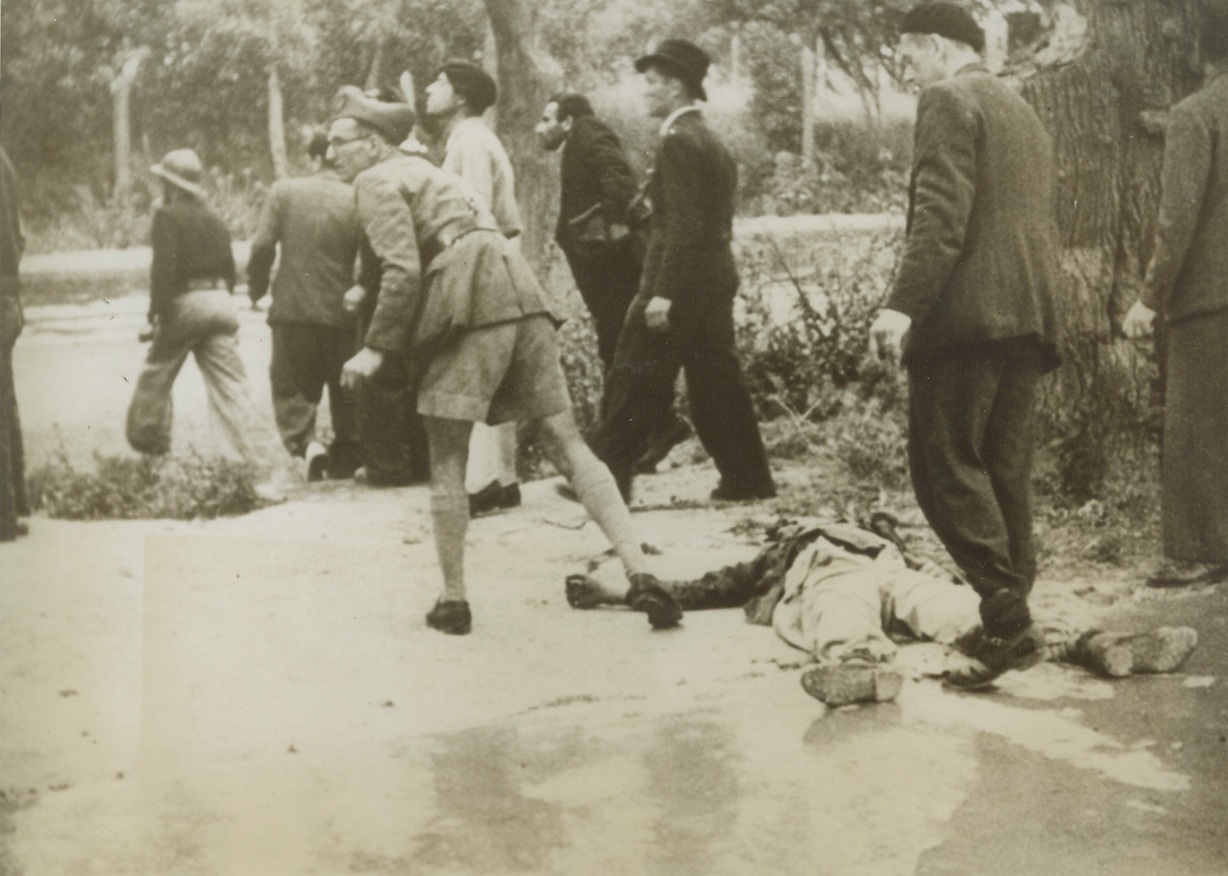 He Wouldn’t Give Up, 5/19/1943. Tunis: - Soldiers and civilians took part in the street fighting that preceded the fall of Tunis.  On the ground is a dead Nazi – he wouldn’t surrender.  He kept firing on British soldiers from a garden before meeting an untimely end. Credit line (ACME);