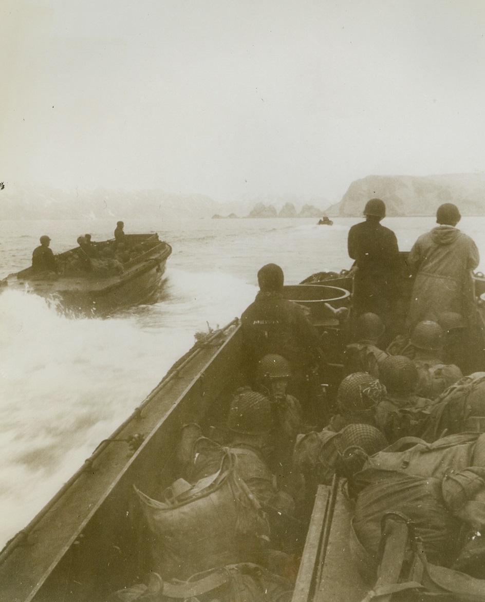 First Photos of Yank Landing on Attu, 5/26/1943. Washington, D.C. -- This photo, one of the first taken of the landing of U.S. troops on Jap-held Attu Island last May 11, was taken by a Navy combat photographer and released in Washington today. Cameramen who took these photos of the landing at two points on the island, Massacre Bay and Holtz Bay, were under Jap fire many times. Here, heavily laden landing boats, with soldiers crouching down out of line of sniper fire, approach the west arm of Holtz Bay. Passed by censor. Credit: U.S. Navy photo from ACME;