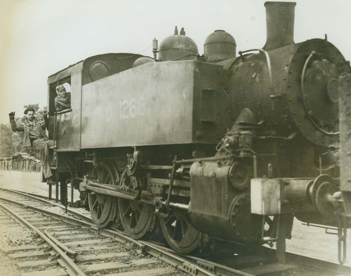 Rolling Along, 5/22/1943. Somewhere in England -- Rolling along the only American-built-and-operated railroad in England, this engine hauls Army supplies to and from Army warehouses. The 17-mile, narrow gauge railroad was built by U.S. Army engineers to facilitate transportation of equipment. Credit: ACME;