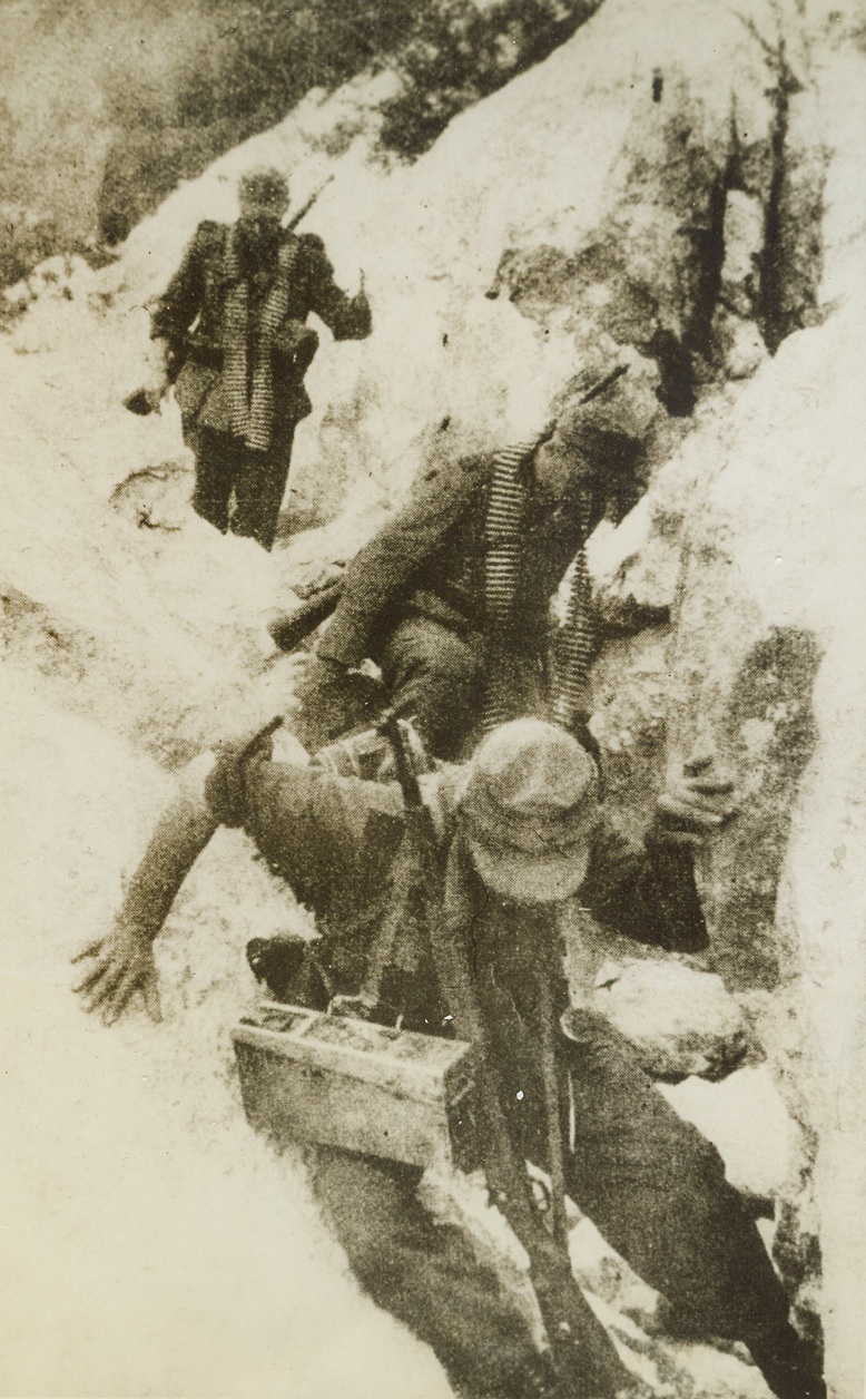 Mountain Climbing Nazis, 1/16/1944. YUGOSLAVIA—Making a shabby showing against the Yugoslav partisan forces led by General Tito, these Nazi warriors are having plenty of trouble with the terrain in which the Guerillas force them to fight. It’s a slippery dangerous trip for these Germans, as they stumble through the snowy mountains of Montenegro photo was obtained through a neutral source. Credit: ACME.;
