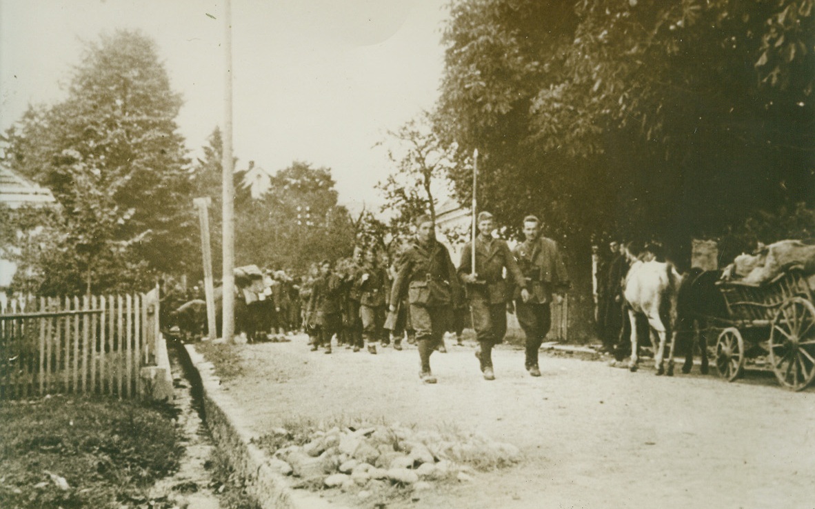 Liberators, 2/9/1944. BOSNIA – Jubilant Yugoslav partisans march triumphantly through a liberated town in Bosnia from which Hitler’s warriors fled. These are Marshal Tito’s men, who are making life miserable for Nazi forces in the Balkans. Credit Line (Acme);