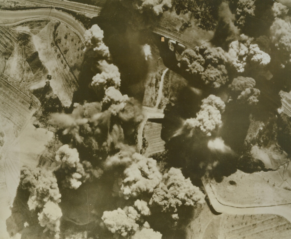 Mission Accomplished, 4/23/1944. ITALY – Clouds of black smoke billow skyward and shroud the target after a Mediterranean Allied Air Forces raid by B-26 Marauders had successfully bombed out the strategic structure. Returning pilots and bombardiers reported an excellent concentration of bombs on this 11-span viaduct at Arezzo, Italy. USAAF Photo from Acme;