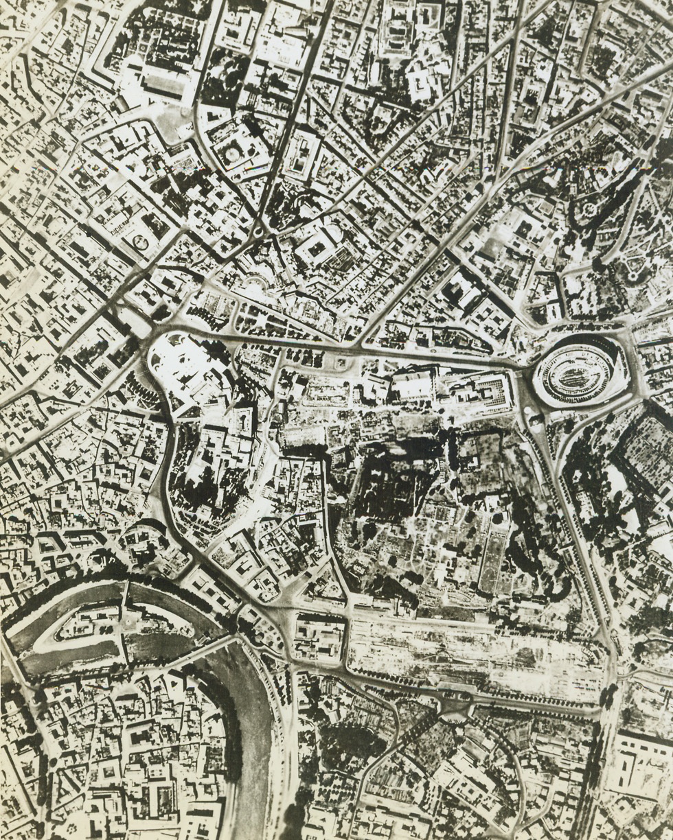 Rome from the Air, 6/4/1944. This aerial view of Rome shows the Colosseum (extreme left, halfway down) with the Via Dell Impero running across from it to the Piazza Venetin (extreme right of the large white building, which is the Victor Emmanuel Monument. Today (June 4) the Allies entered the outskirts of Rome under fierce enemy resistance. Reports say that hand-to-hand street fighting is in progress. Credit: ACME.;
