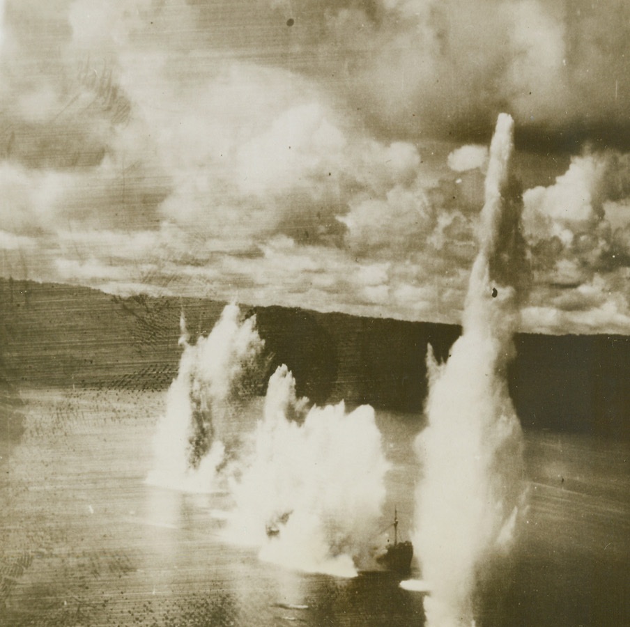 DOOM FOR JAP FREIGHTER, 6/30/1944. NEW GUINEA—Caught off the northern coast of New Guinea by a surprise attack by B-25’s of the 5th Air Force, this Jap freighter was soon crippled by bombs and machine gun fire. As it wallowed helplessly in the water a bomber moved in and scored a direct hit-spelling finis for the Jap boat.Credit: USAAF PHOTO FROM ACME.;