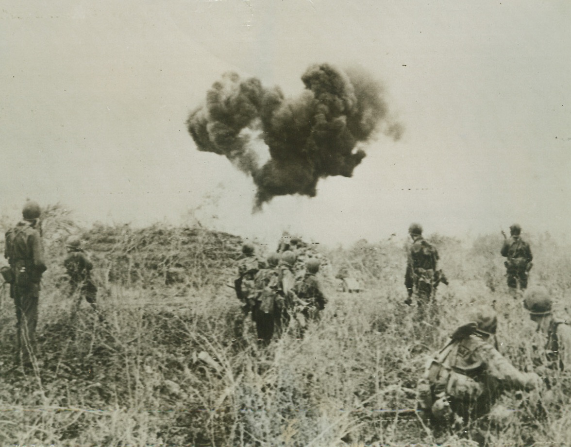Flamethrowers at Work, 6/24/1944. Saipan, Marianas – US Infantrymen, creeping up on a Jap pillbox on Saipan, pause while a flamethrower disposes of the entrenchment. Although the Japs have been putting up fierce resistance, the Yanks have been making steady inroads into their territory. Today (June 24) fighting continues in the Garapan Area. Credit: Signal Corps Radiotelephoto from ACME;