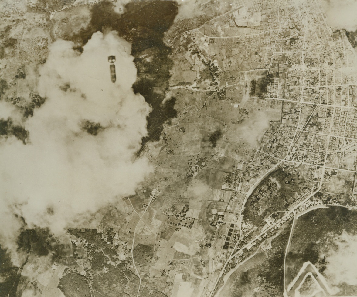 Blast Saipan Harbor, 6/17/1944. Saipan Islands – a bomb from a Navy bomber of the Pacific fleet falls on Japanese installations at Tanapag Harbor on Saipan island in the Marianas.  Odd design in lower left-hand corner is a dredging channel and small boat basin.  American troops on Saipan have succeeded in extending their bitterly fought for beachheads and have beaten back a Jap counterattack. Credit (US Navy photo from ACME);