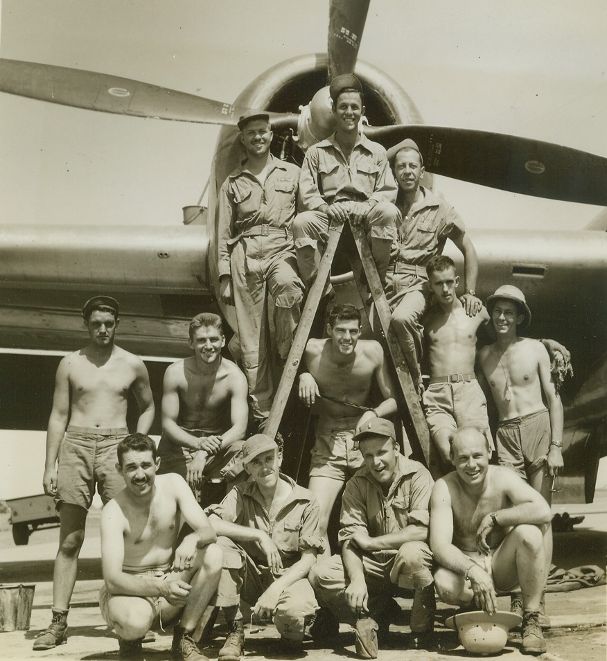 Crew of “Superfortress”, 6/18/1944. China – It has now been established that the new B-29 superfortresses of the 20th bomber command which rocked Japan recently flew from a Chinese base.  Before taking the bombers on the maiden mission, crews had been thoroughly trained in manning these super aircraft, different from any heavy planes manufactured thus far in the war.  Here is one of the crews of a B-29.  Left to right, standing on ground an ladder: Sgt. B. Patterson, gunner, Oil City, Pa.; Sgt. J. Chobot, gunner, Dearborn, Mich.; Sgt. D. Nebeker, Jr. guner, Salt Latke City, Utah; Sgt. D.G. Hales, crew chief, Corsicana, Tex., Sgt. J.S. Parto, Radio operator, Hazelton, Pa.; Sgt. R.B. Moble, radio, Williamsburg, Pa.; and Sgt. M.P. Plant, gunner, Long view, Wash.  Standing in the center of the ladder is flight officer J.C. Martin (English), Sweetwater, Tec. Kneeling, left to right; Maj. H.R. Brown, pilot, Ardmore, Tenn.; lt. W. Stern, bombardier, Rockford, Ill.; Lt. J. Goeringer, co-pilot, Fresno, Calif.; and Lt. A.C. Beach, navigator, Morgantown, Pa. Credit (ACME photo by Frank Cancellare, War Pool correspondent);