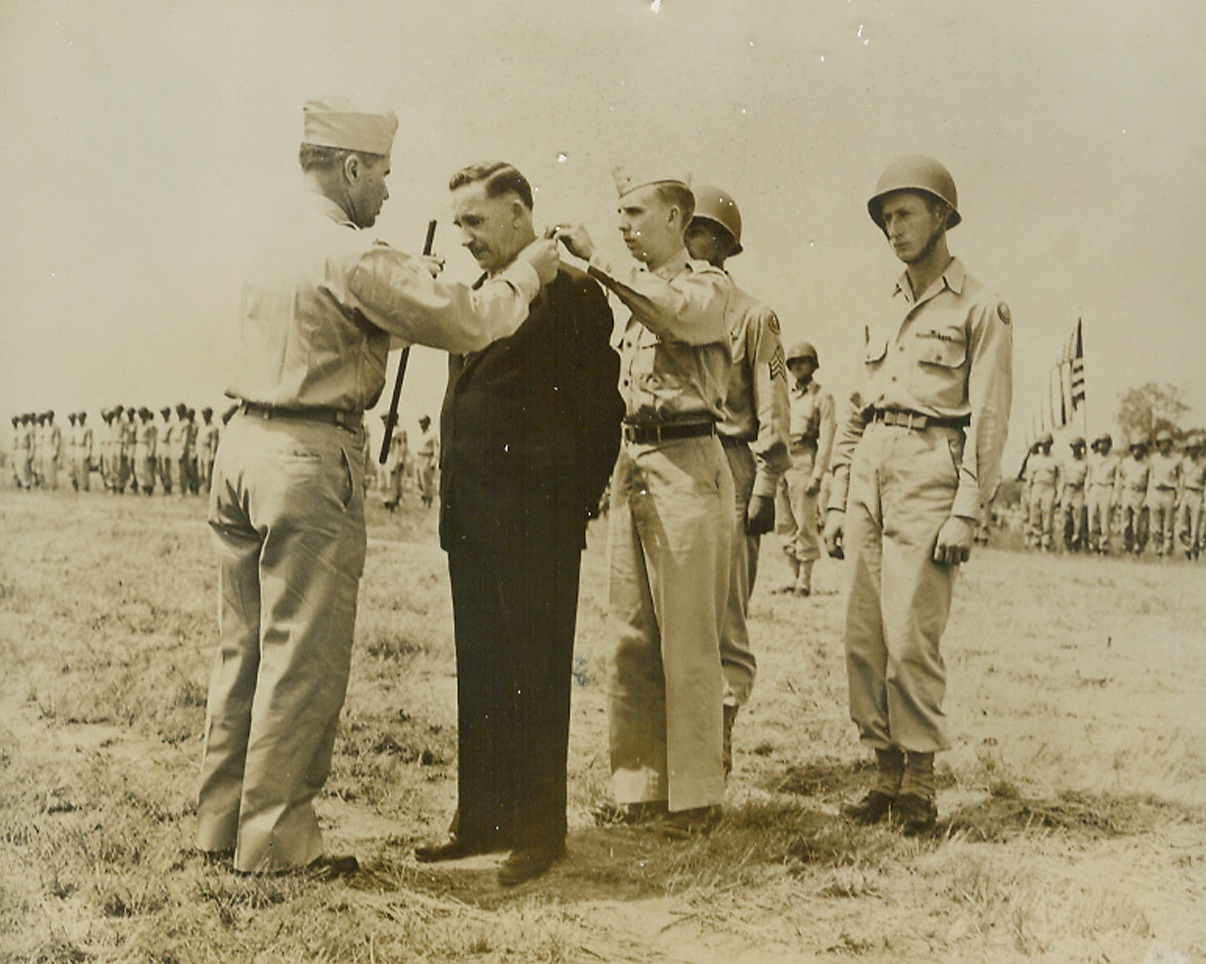 Hero’s Father Gets Medal, 6/16/1944. Camp Atterbury, Ind.—William F. Craig, Toledo, Ohio, receiving the Congressional Medal of Honor awarded posthumously to his son 2nd Lt. Robert Craig for silencing a machine gun nest at Favoratta, Italy, and drawing enemy fire toward himself so his platoon could take cover after they were caught in a trap. Maj. Gen. Alan W. Jones, commanding officer of the 106th infantry division, and Lt. Marvin Rusch decorate Craig.  Credit: ACME.;