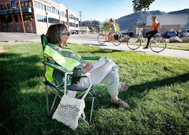 Woman counting people walking and biking.